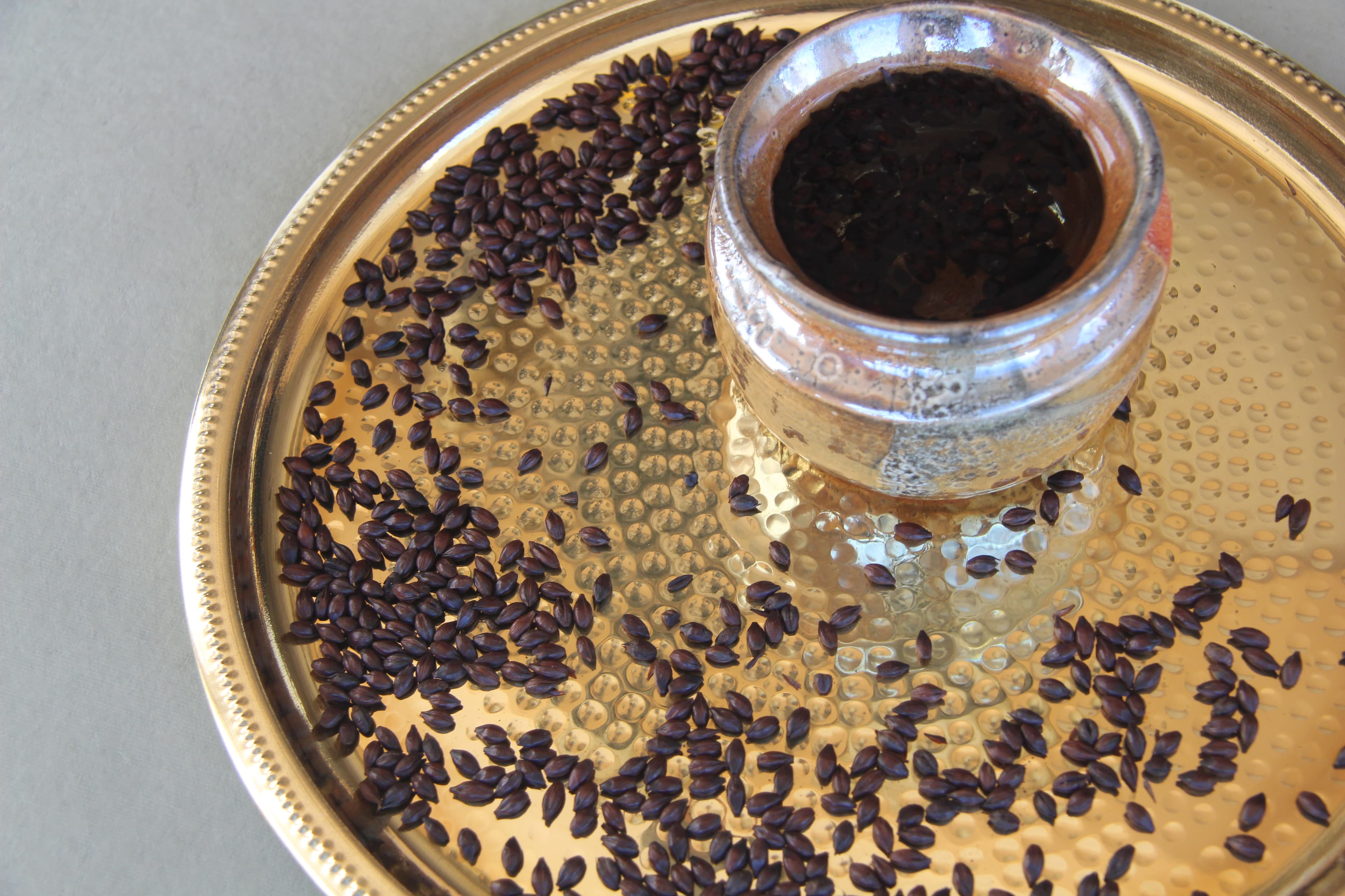 A cup of tea in an earthenware cup on a rustic wooden table